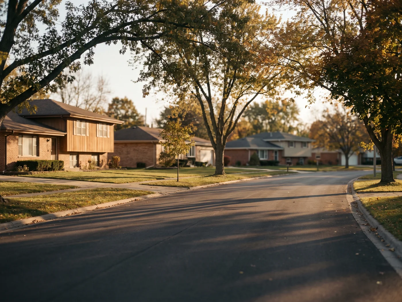 A wide tree lined suburban street at golden hour. Inspired Law Group serves Bolingbrook and the surrounding Will County communities.
